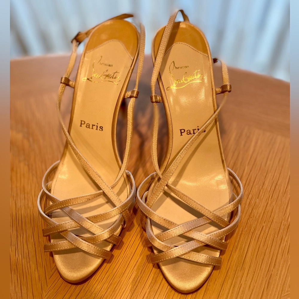 Gently used Christian Louboutin champagne colored sling-back sandals